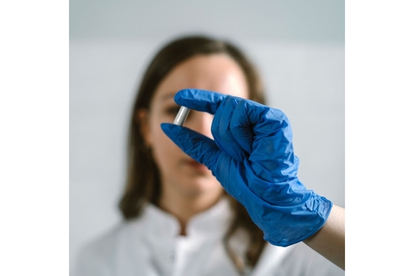 Image A scientists holds a test tube.